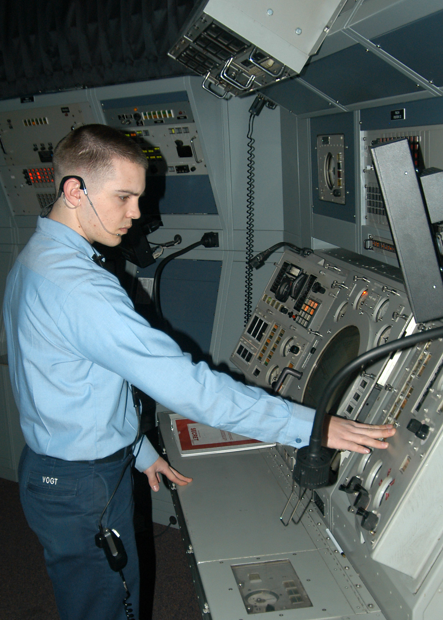 Oceanside — US Navy 070226-N-6247M-005 Air Traffic Controller 3rd Class Stephen Vogt, from Oceanside, Calif., monitors the Automatic Carrier Landing System that controls aircraft down to 200 feet and half a mile from the airfield