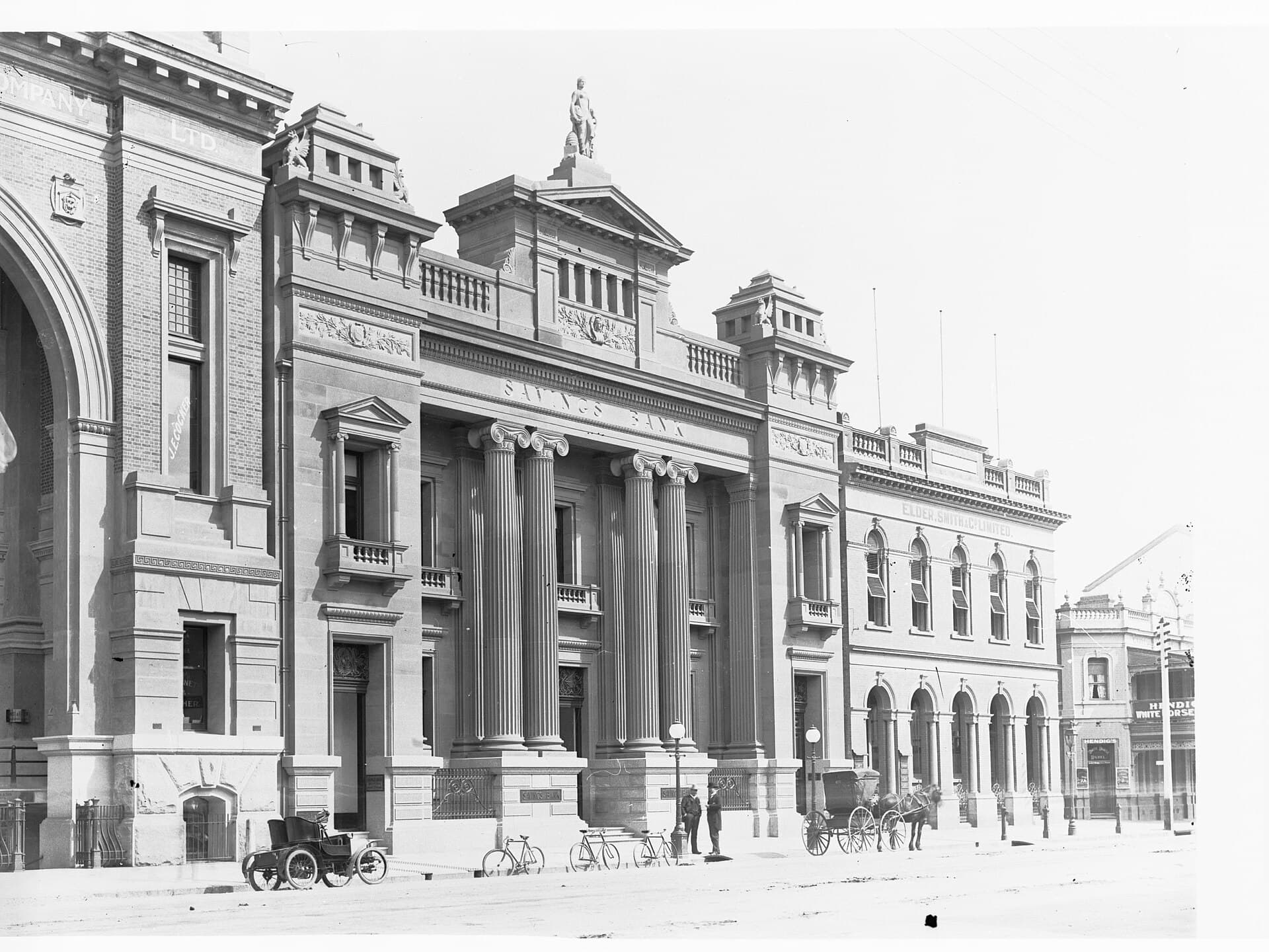 Whitehorse — Savings Bank on Currie Street - Adelaide Steamship Company building to left of photo and Elder Smith & Co. and Whitehorse Hotel to right of photo(GN03174)