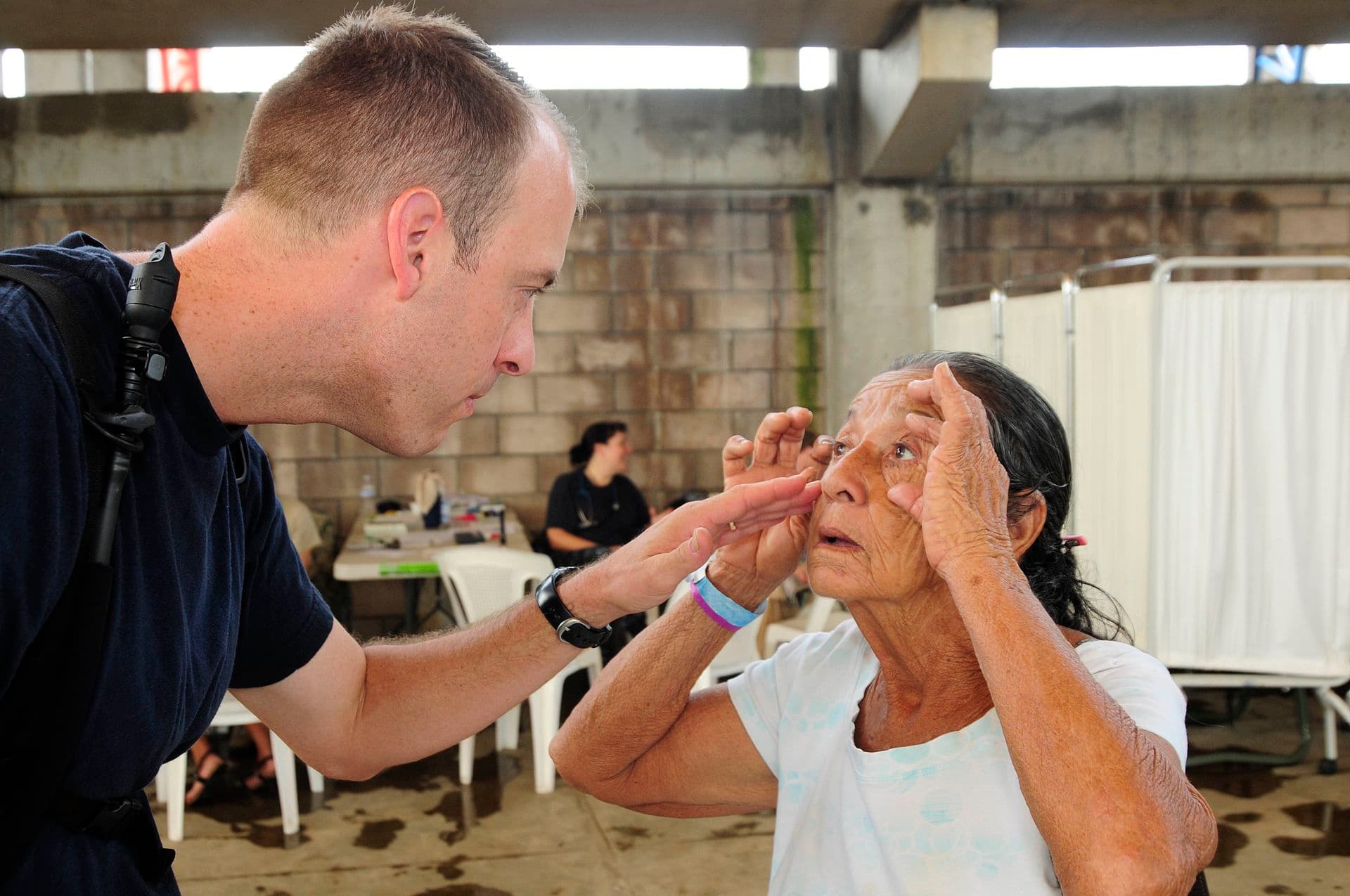 Livermore — US Navy 110717-N-EP471-275 Lt. j.g. Jerry Brown, from Livermore, Iowa, looks into a Salvadoran woman's eyes as she waits to receive medical care du
